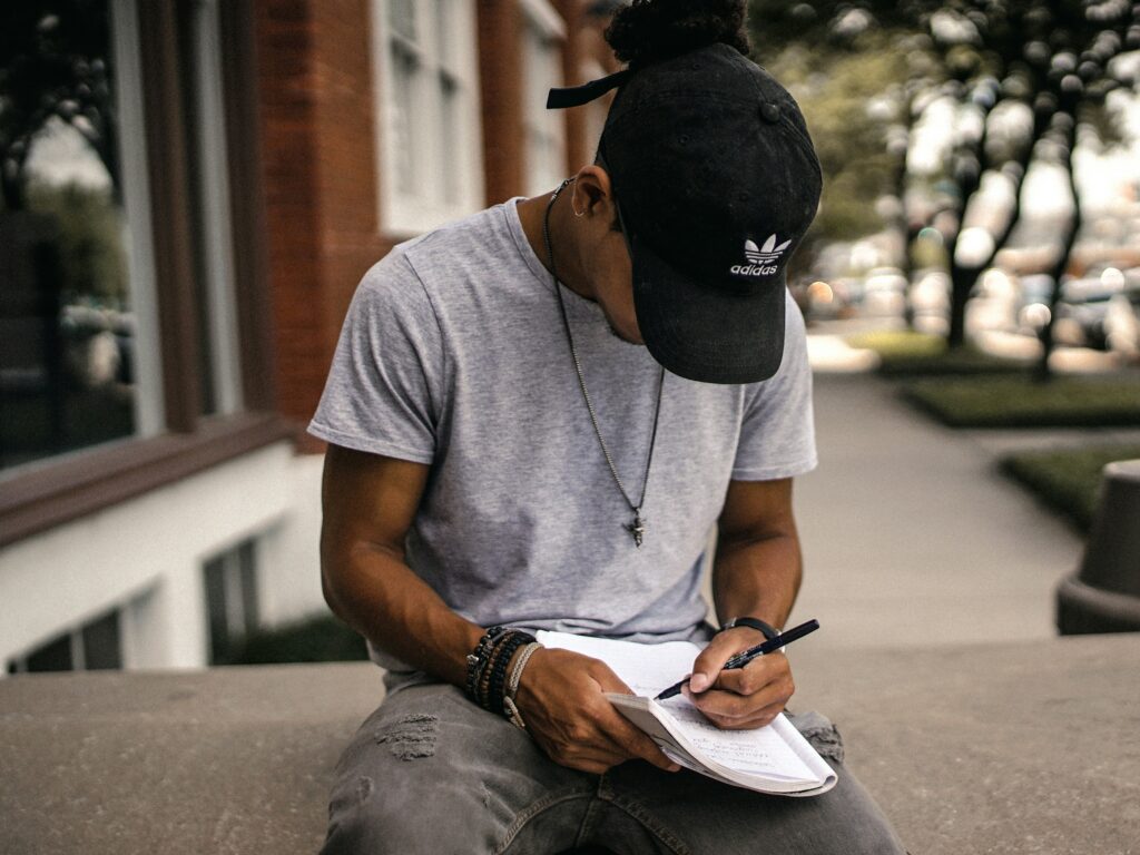 someone writing down daily spending to track money habits